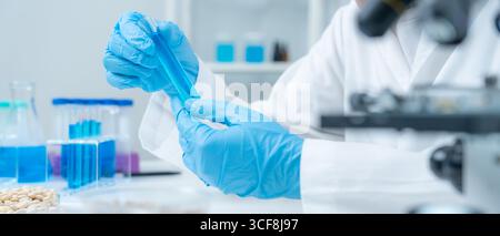 Scientist analyze biochemical sample in advanced scientific laboratory. Medical professional check chemical mix microbiological developmental of viral Stock Photo