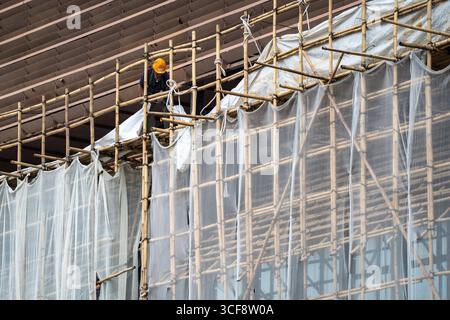 A general view showing a bamboo scaffolding theater under construction ...