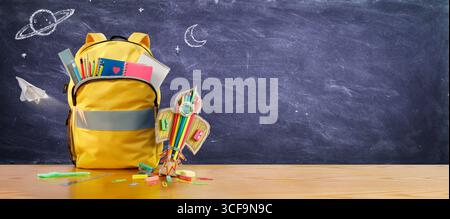 Back To School - Rocket and Schoolbag With Pencils And Stationary On Blackboard Stock Photo