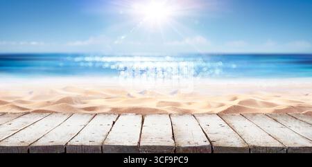 Tabletop Beach Summer - Wooden Plank With Abstract Defocused Glittering On Sea Stock Photo