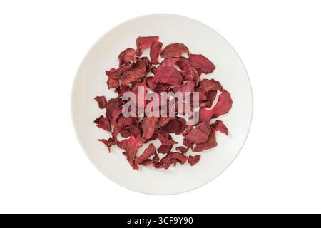 Dried beetroot on a ceramic plate isolated on a white background. Ingredient for preparing a freeze-dried lunch. Top view. Stock Photo