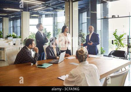 Presentation speech by business leader and speaker for corporate team in office conference room Stock Photo