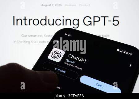 ChatGPT app on Android held before Introducing GPT-5 webpage showing OpenAI product launch headline. Stafford, United Kingdom, August 21, 2025 Stock Photo