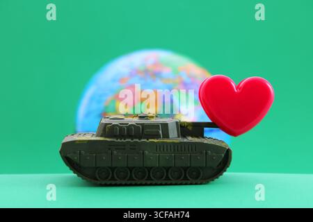 Love stops war in the world, and the heart puts an end to the armed conflict Stock Photo
