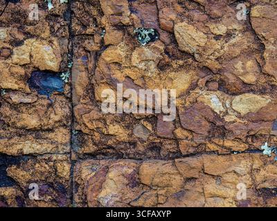 The texture of a rock wall with some lichen on it, found in a hill of the outskirts of the town of Cucaita, in the eastern Andean mountains Stock Photo