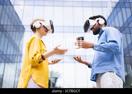 People Using VR Headsets Outdoors Stock Photo
