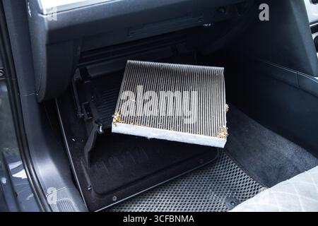 Old dirty carbon cabin filter of the car. Concept of replacement with a new one. Cleaning the air in the car cabin Stock Photo