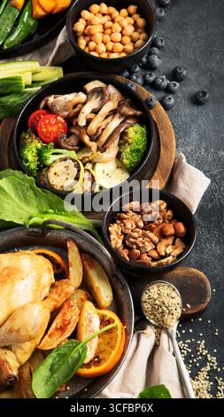 Various food of meat dishes, fish, salads, garnish and snacks on a black background. Top view. Stock Photo