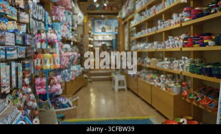 Souvenir shop indoors featuring vibrant ceramics and keepsakes in a brightly lit setting with a defocused, blurry background creating a bokeh effect a Stock Photo