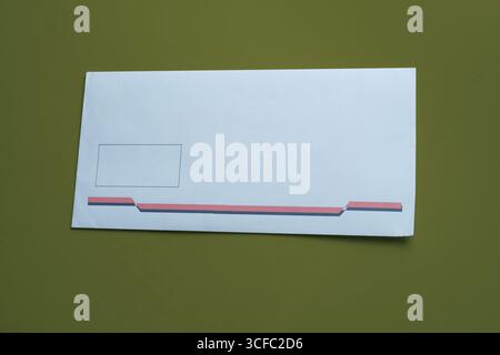 White envelope isolated on green background. Stock Photo