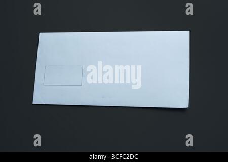 Blank white envelope isolated on black background. Stock Photo