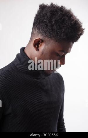 Serious authoritative bearded man standing looking down in front of the camera against white studio background Stock Photo