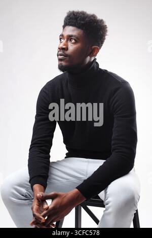 Serious authoritative bearded man standing looking up in front of the camera against white studio background. Human appearance concept Stock Photo