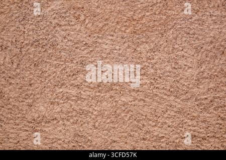 Background with macro detail of rough brown painted exterior facade cement wall. Front view. Stock Photo