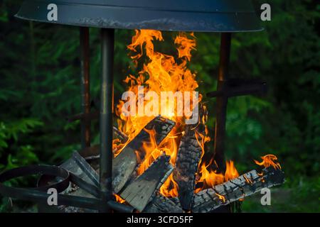 Burning Firewood in an Outdoor Fire Pit Stock Photo
