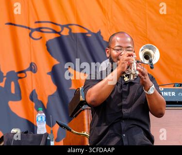 New Orleans, LA, USA - April 30, 2022: Galactic trumpeter Eric Gordon plays a solo at the 2022 New Orleans Jazz and Heritage Festival Stock Photo