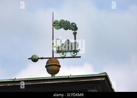 Steam locomotive with lots of smoke. Weather vane on the roof of the main railway station. Freudenstadt, Baden-Wuerttemberg, Germany Stock Photo