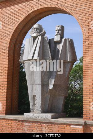 Granite, cubist style statues of Marx and Engels at the entrance to Memento Park, Memorial Park, Szoborpark, Budapest, Hungary Stock Photo