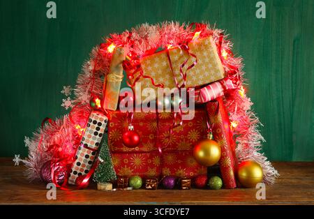 Christmas shopping and christmas present concept with gift wrapped Christmas present boxes and Christmas lights and decoration. Stock Photo