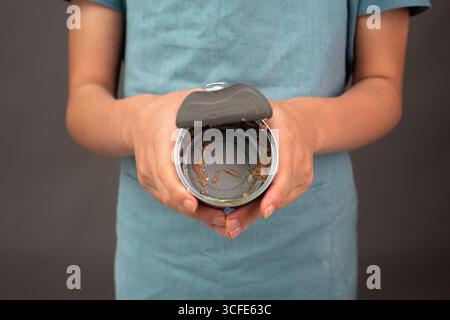 Open Tin Can With Preserved Food, Empty Box Of Tuna Fish, Processed Ingredients, Feeding A Pet Stock Photo