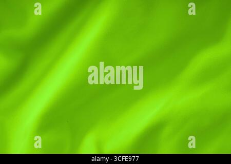 Neon lime green fabric with soft folds , textile texture close-up Stock Photo