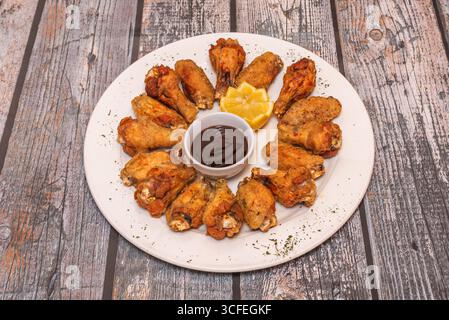 Fried wings coated in chipotle and coffee sauce, deep smoky flavors with an earthy touch Stock Photo