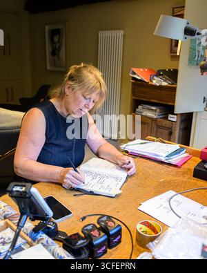 Woman Writing in a diary Stock Photo