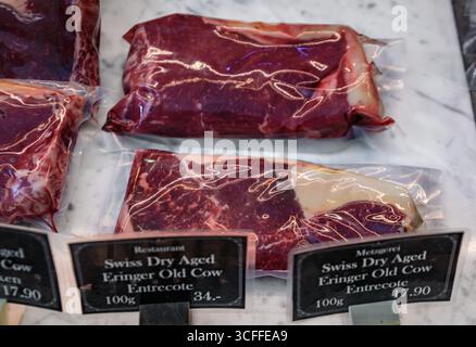 Vacuum sealed cuts of entrecote sirloin from Swiss dry aged Eringer or Herens Old Cow beef are on display at a butcher shop in Zurich, Switzerland Stock Photo