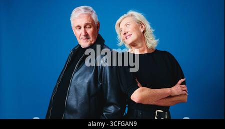 Fashion, happy and senior couple in studio for trendy outfit, cool clothes and pose together. Marriage, space and mature man and woman with attitude Stock Photo