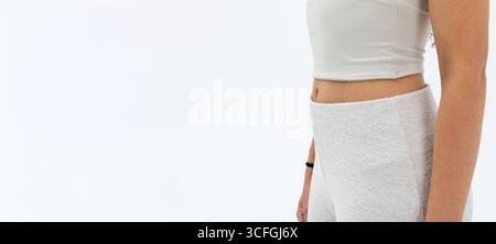 A fashionable woman is showcasing stylish athleisure wear against a clean white background Stock Photo
