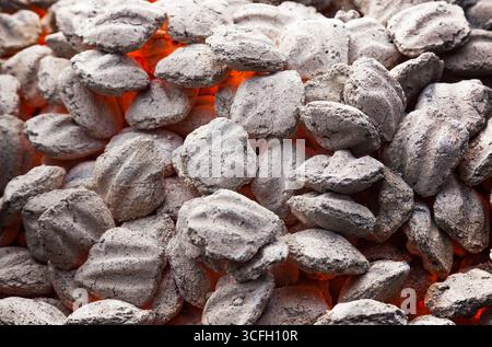 Close-up of smoldering charcoal and heat from the coals. Stock Photo