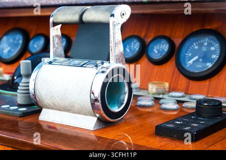 Motor yacht control panel. Gear levers, gauges, speedometers and control buttons. Stock Photo