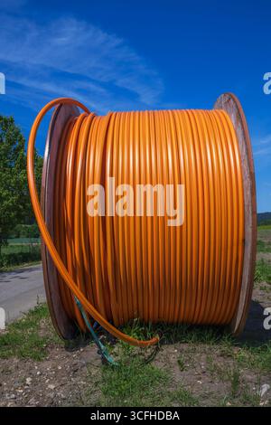 Construction site with a fiber optic cable roll for digital broadband internet communication. Stock Photo