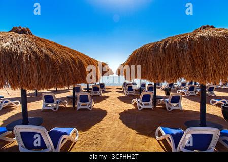 Deck chairs and sun beds on the beach of Sharm el Sheikh, Egypt. Stock Photo