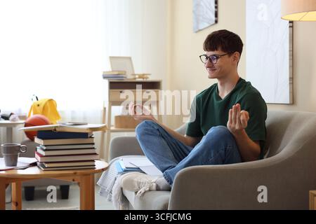 Student preparing for exam and meditating at home Stock Photo