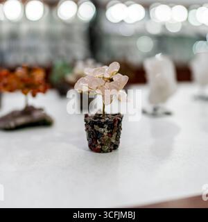 Rose quartz gemstone tree in a mineral pot. Handmade decorative stone bonsai used for feng shui, energy balance, and unique gemstone collections. Stock Photo