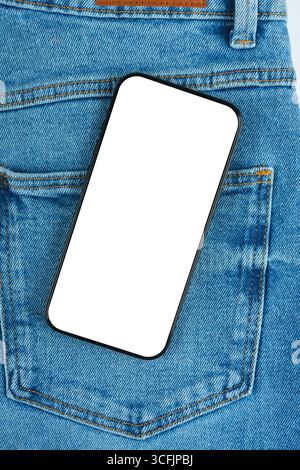 Mockup, template of modern smartphone with blank white screen with copy space, partially placed on blue denim jeans pocket. Technology, fashion or lif Stock Photo