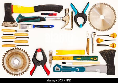 Flat lay of new and used hand tools on white background. Large collection of various tools and bits arranged on white. Stock Photo