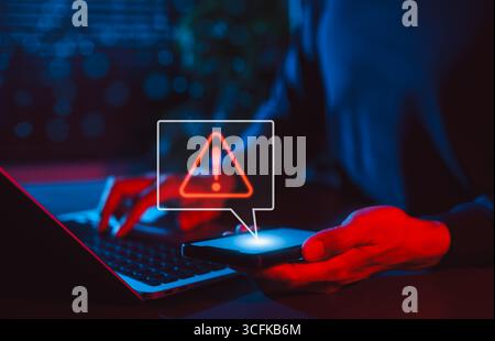 Mobile Security Alert and Cyber Threat Notification. Man holding smartphone with red warning sign and exclamation mark, symbolizing secure, Stock Photo