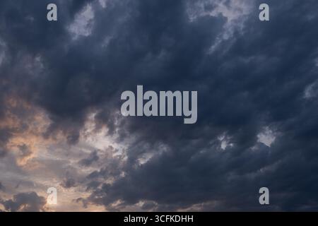 Dramatic sky with stormy clouds at sunset. Nature background Stock Photo