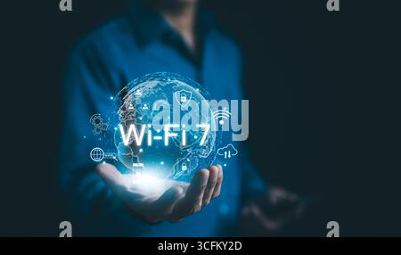 Global Wi-Fi Connectivity and Internet Technology Concept. A person holding a holographic globe highlighting Wi-Fi 7 connectivity, Stock Photo