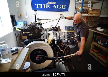 Printer Adrian Manning working with a vintage Heidelberg letterpress printing machine in his Devon workshop. Stock Photo