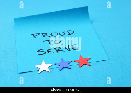 Proud to Serve,  phrase on sticky note and three stars Stock Photo