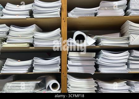 A lot of documents on the shelves of archive room in the office. Paperwork concept. Stock Photo