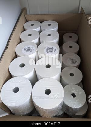Spare thermal printer rolls for receipt printing stacked in white packaging Stock Photo