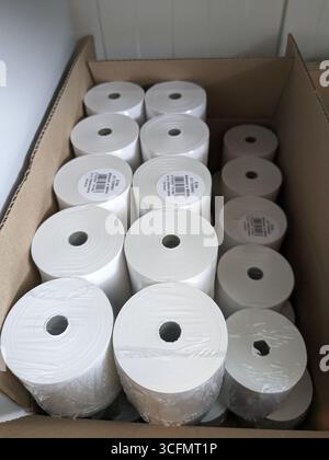 Spare thermal printer rolls for receipt printing stacked in white packaging Stock Photo