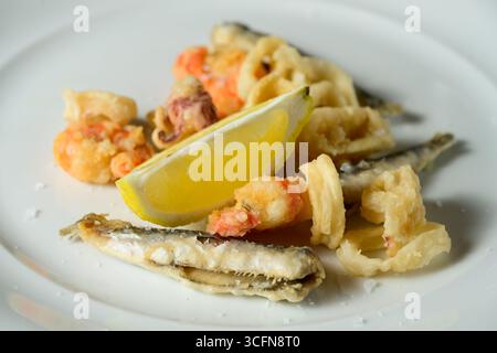 Fritto Misto del Golfo Fried Fish with Calamari, Prawns and Sardines Garnished with Lemon Stock Photo