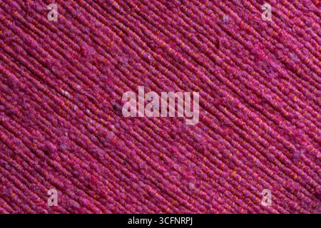 Pink texture of natural eco fabric, close up . Background of red rough fabric Stock Photo
