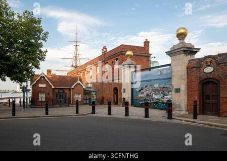 Entrance to Portsmouth Historic dockyard with the masts of HMS Warrior in the background. August 2025. Stock Photo
