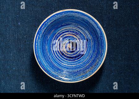 Empty blue bowl on fabric background, close up, top view Stock Photo